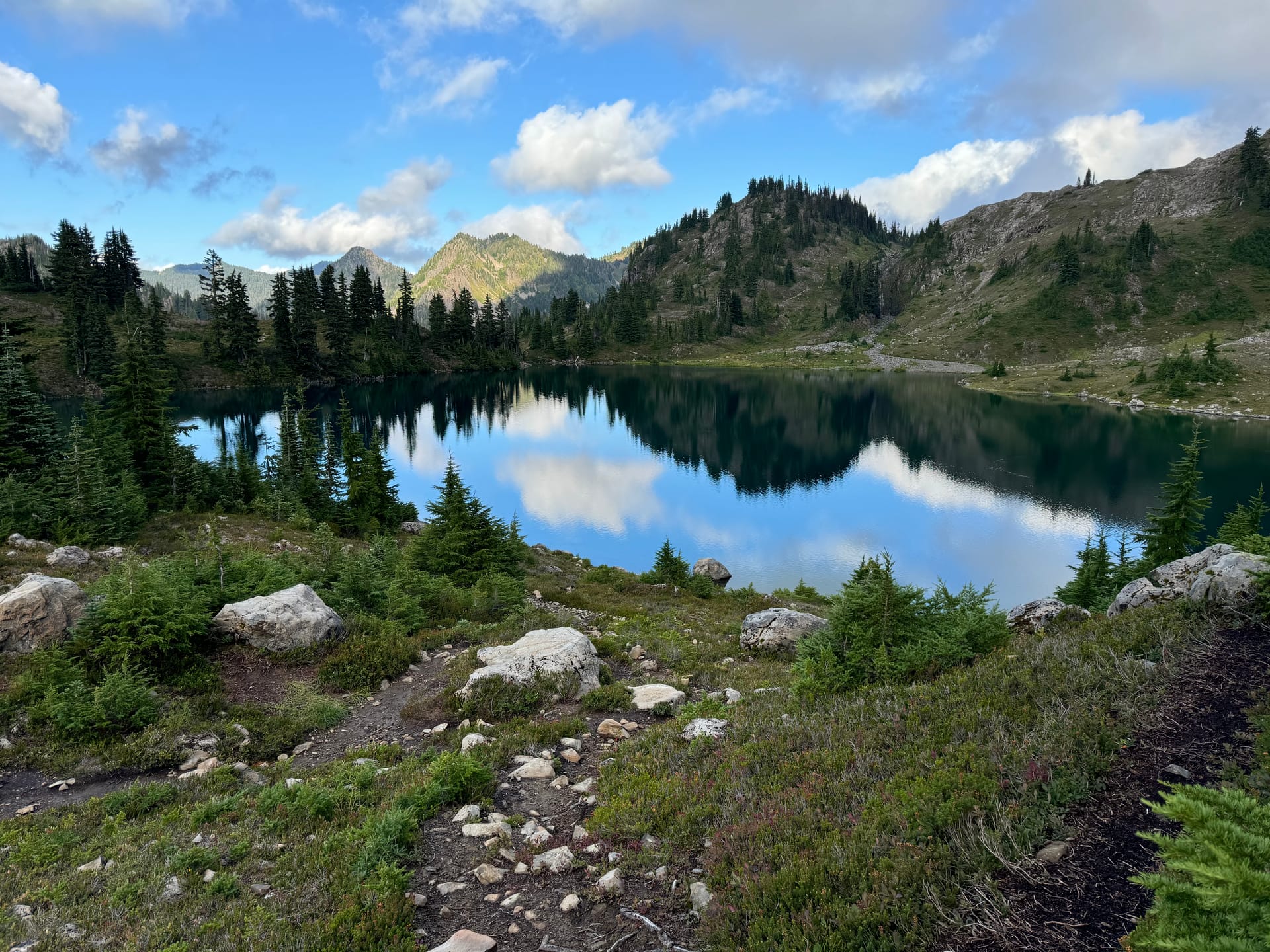 An alpine lake in the Olympic Mountains, reflecting the ridge line on a still morning